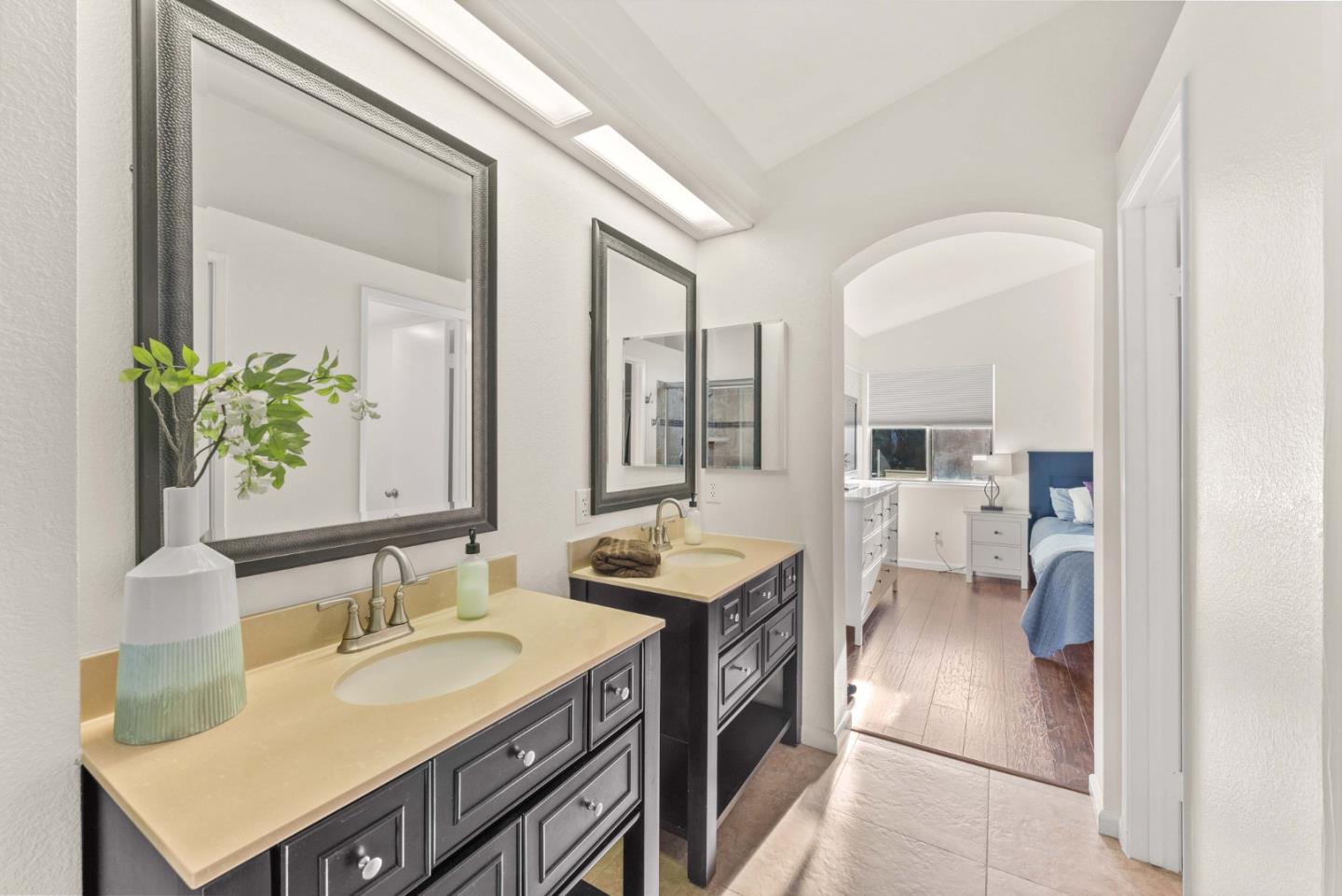 7385 Forsum Road San Jose, CA 95138 - Photo 19 of 40 a en suite bathroom with a granite countertop sink and a mirror