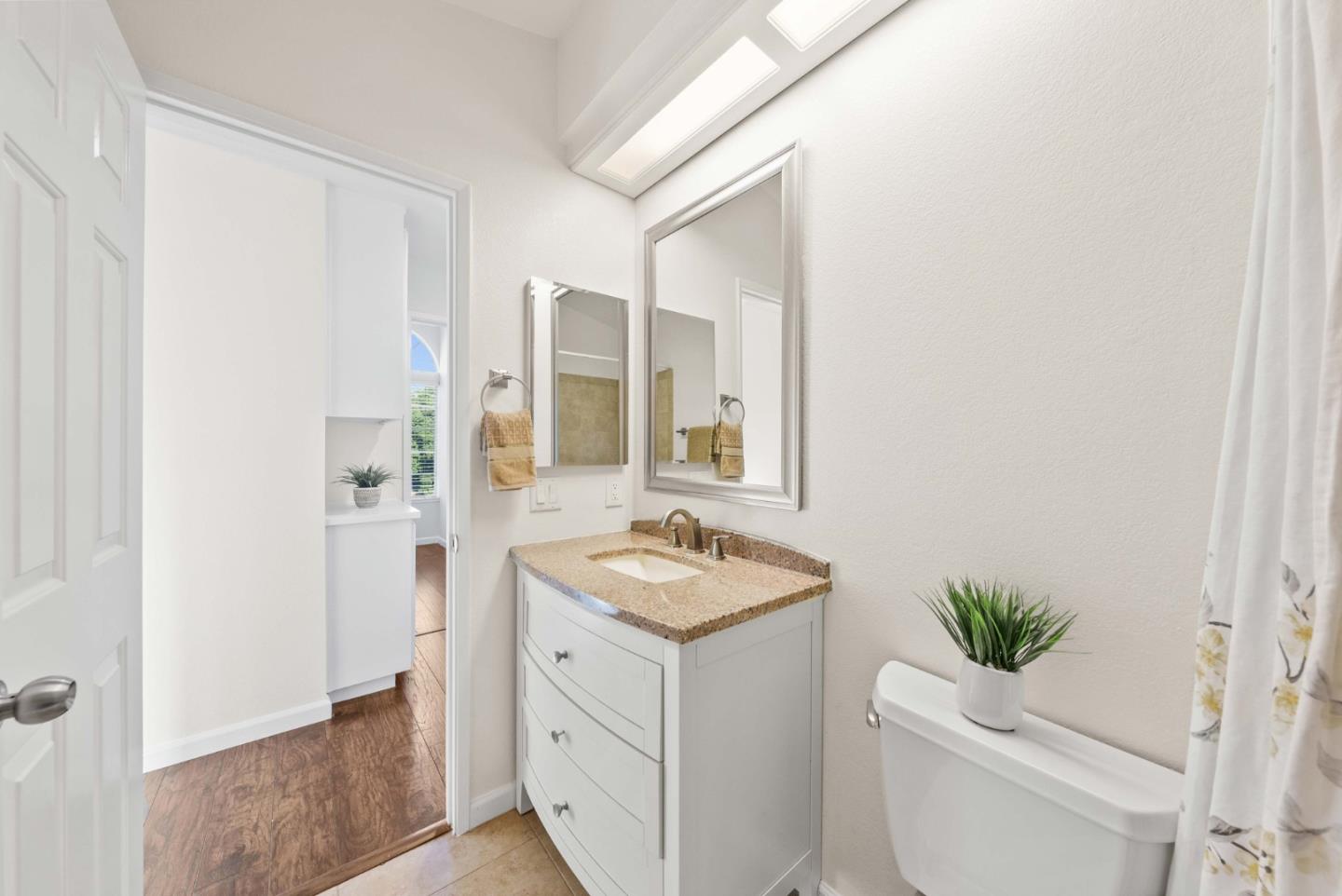 7385 Forsum Road San Jose, CA 95138 - Photo 26 of 40 a bathroom with a granite countertop sink and a mirror