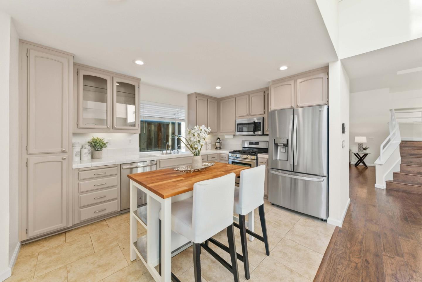 7385 Forsum Road San Jose, CA 95138 - Photo 6 of 40 a kitchen with stainless steel appliances granite countertop a refrigerator and a stove top oven