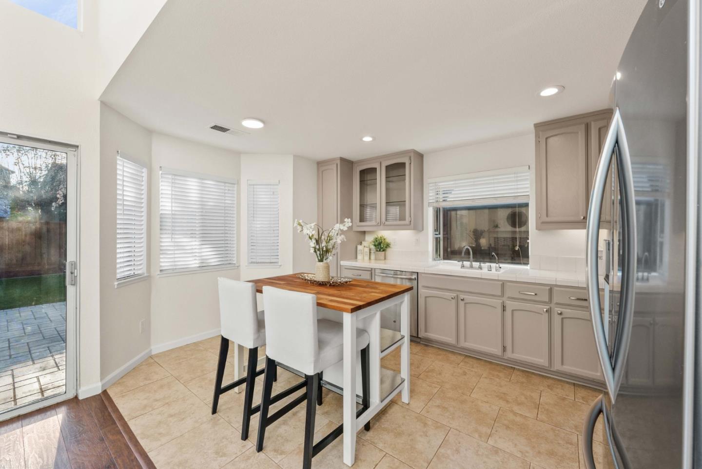 7385 Forsum Road San Jose, CA 95138 - Photo 7 of 40 a kitchen with stainless steel appliances granite countertop counter space and a refrigerator