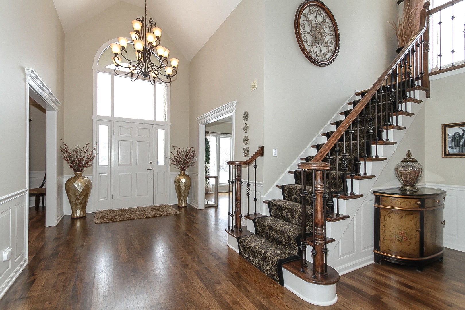 6N734 Henricksen Road St. Charles, IL 60175 - Photo 4 of 40 a view of a hallway with wooden floor and a chandelier