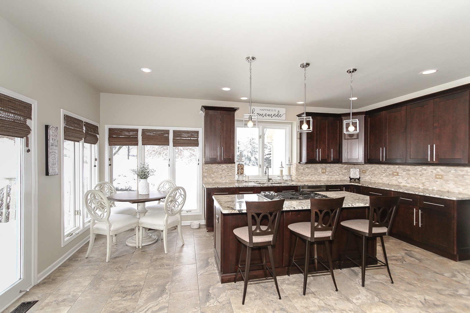 6N734 Henricksen Road St. Charles, IL 60175 - Photo 8 of 40 a kitchen with stainless steel appliances kitchen island granite countertop a table chairs and a refrigerator