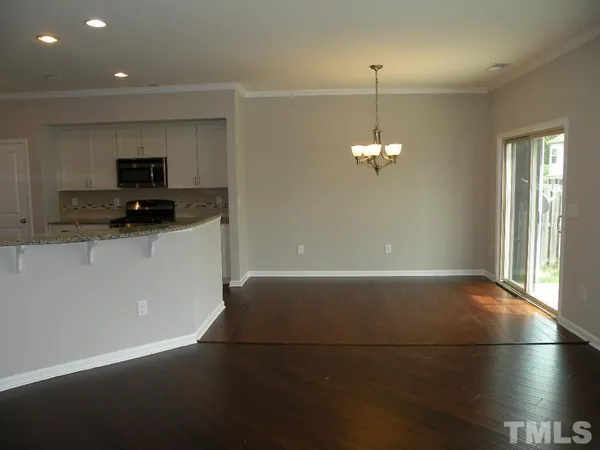 a kitchen with stainless steel appliances a refrigerator and a stove top oven