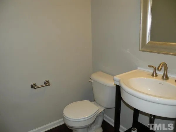 a white toilet sitting next to a bathroom sink