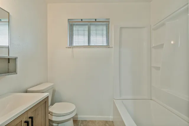 a bathroom with a toilet a sink and a bath tub