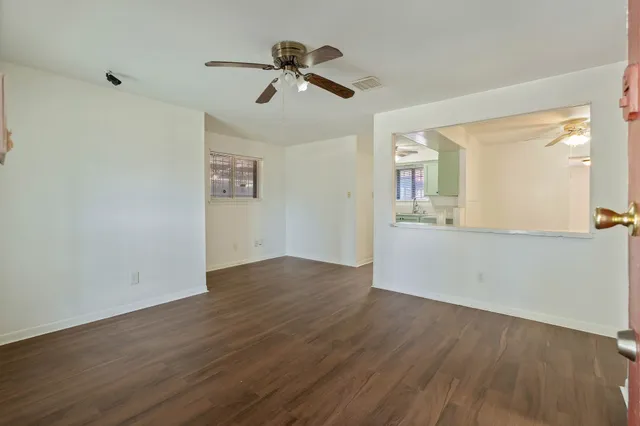 wooden floor in an empty room with a window