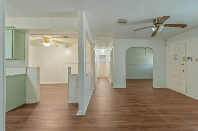 a view of a hallway view with wooden floor and staircase