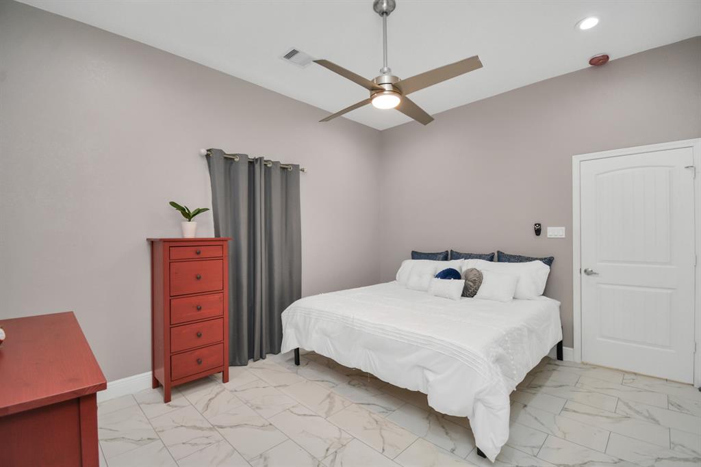 2705 Fox Street Houston, TX 77003 - Photo 18 of 20 a bedroom with a bed and a dresser