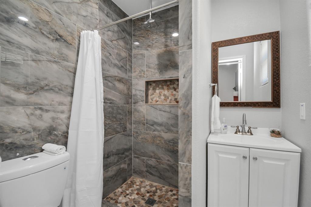 2705 Fox Street Houston, TX 77003 - Photo 20 of 20 a bathroom with a shower toilet and sink