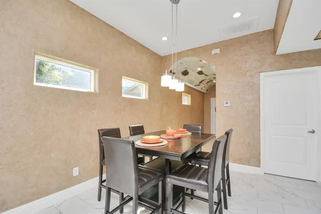 a dining room with furniture and window