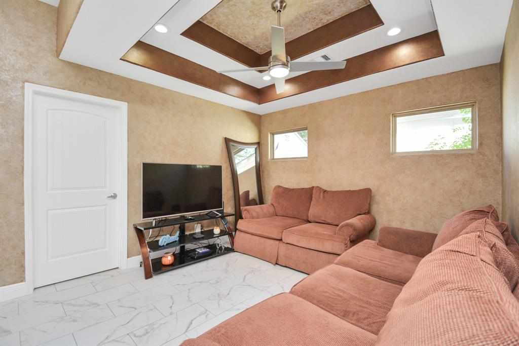 2705 Fox Street Houston, TX 77003 - Photo 9 of 20 a living room with furniture and a flat screen tv