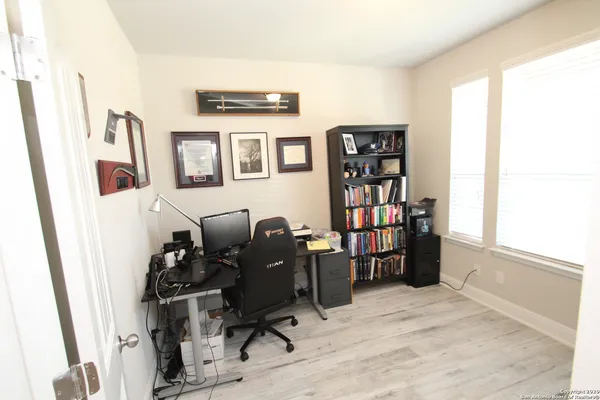 a view of a workspace with furniture and a window