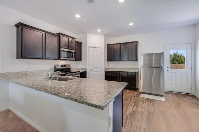 a kitchen with a sink microwave and refrigerator