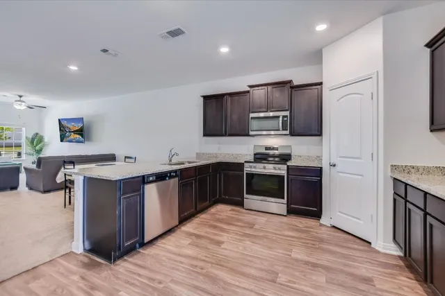a view of backyard with wooden fence