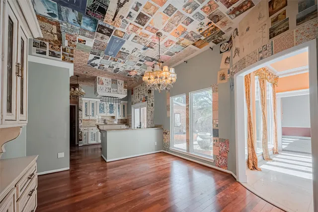 a view of a big room with wooden floor and windows