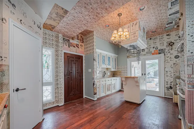 a view of a kitchen with furniture and wooden floor