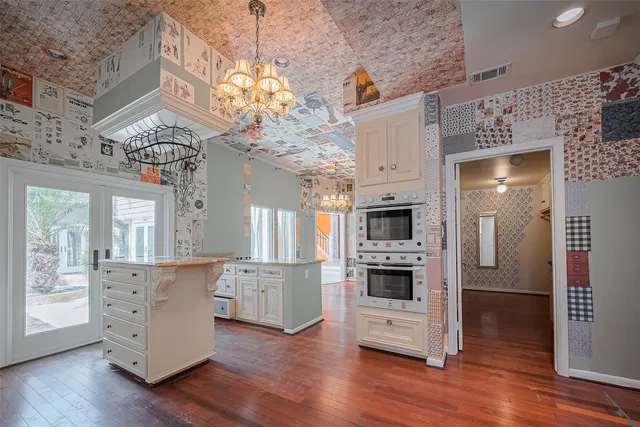 a view of a kitchen with furniture and wooden floor