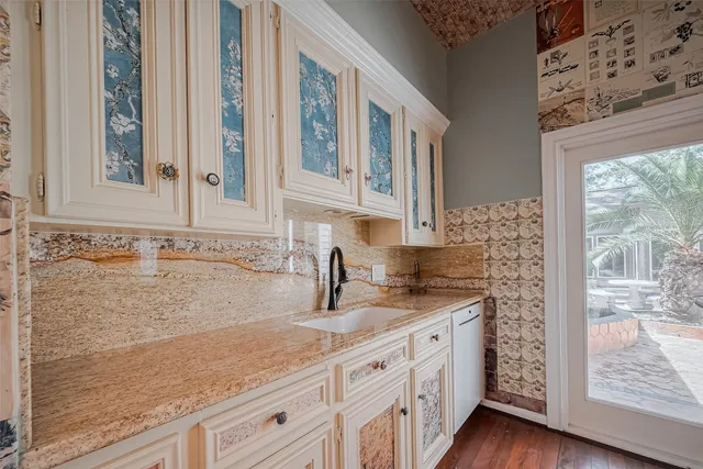 a kitchen with granite countertop a sink and a stove