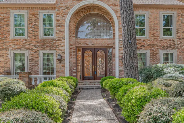 a front view of a house with garden