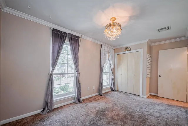 a backyard of a house with fountain table and chairs