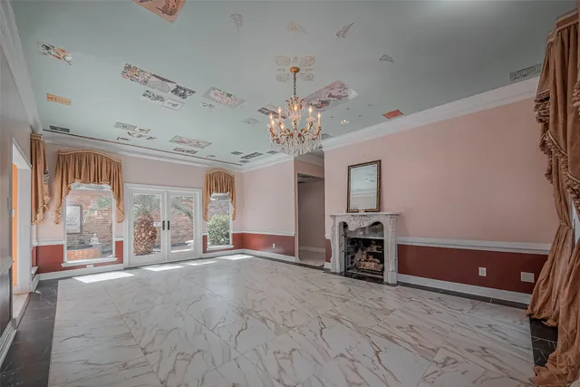 a view of a livingroom with a chandelier furniture and windows