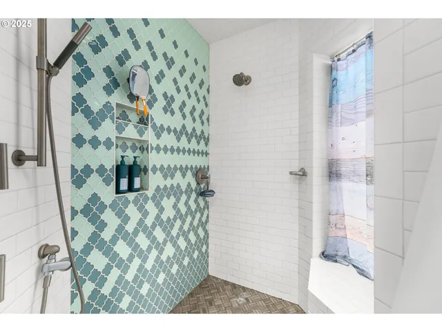 a bathroom with a shower and a sink