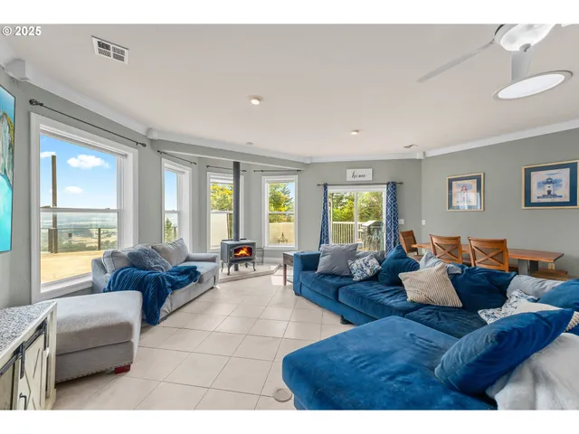 a living room with furniture and large windows