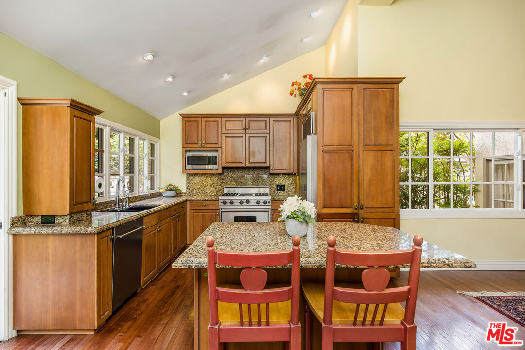 2124 Eric Drive Los Angeles, CA 90049 - Photo 11 of 30 a kitchen with granite countertop a sink and a stove top oven