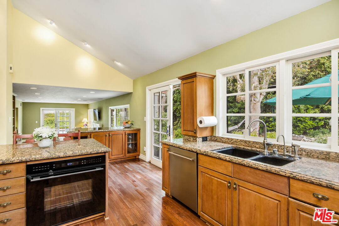 2124 Eric Drive Los Angeles, CA 90049 - Photo 14 of 30 a kitchen with granite countertop a sink and a stove top oven