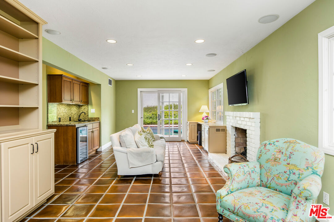 2124 Eric Drive Los Angeles, CA 90049 - Photo 15 of 30 a living room with fireplace furniture and a flat screen tv