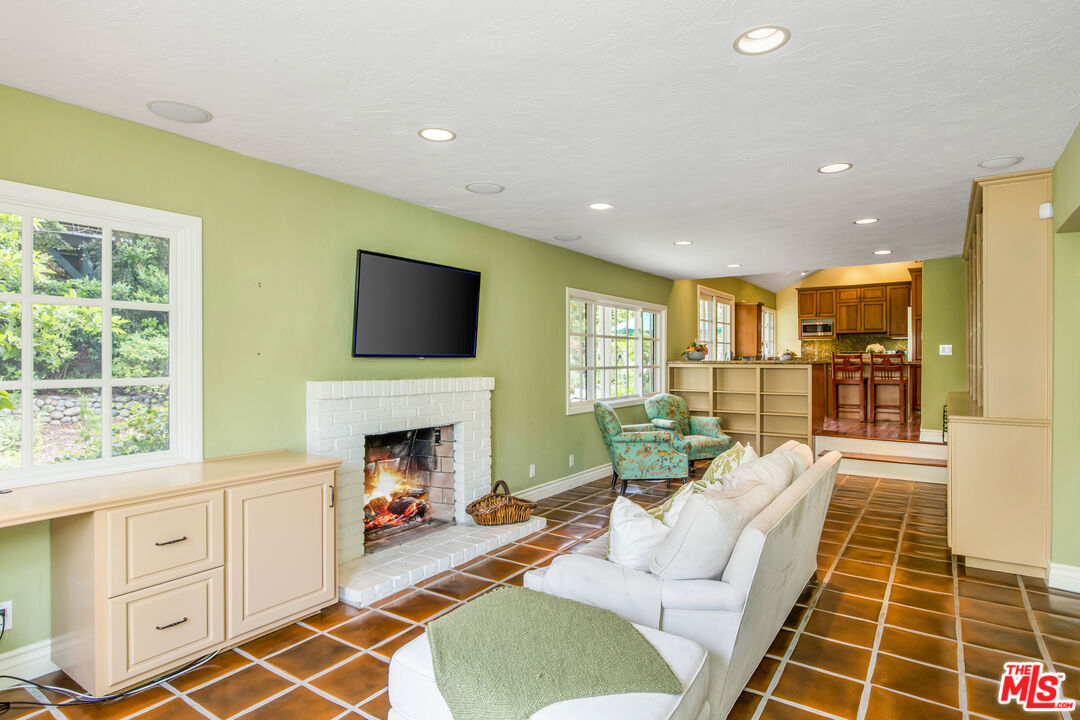 2124 Eric Drive Los Angeles, CA 90049 - Photo 16 of 30 a living room with furniture a flat screen tv and a fireplace