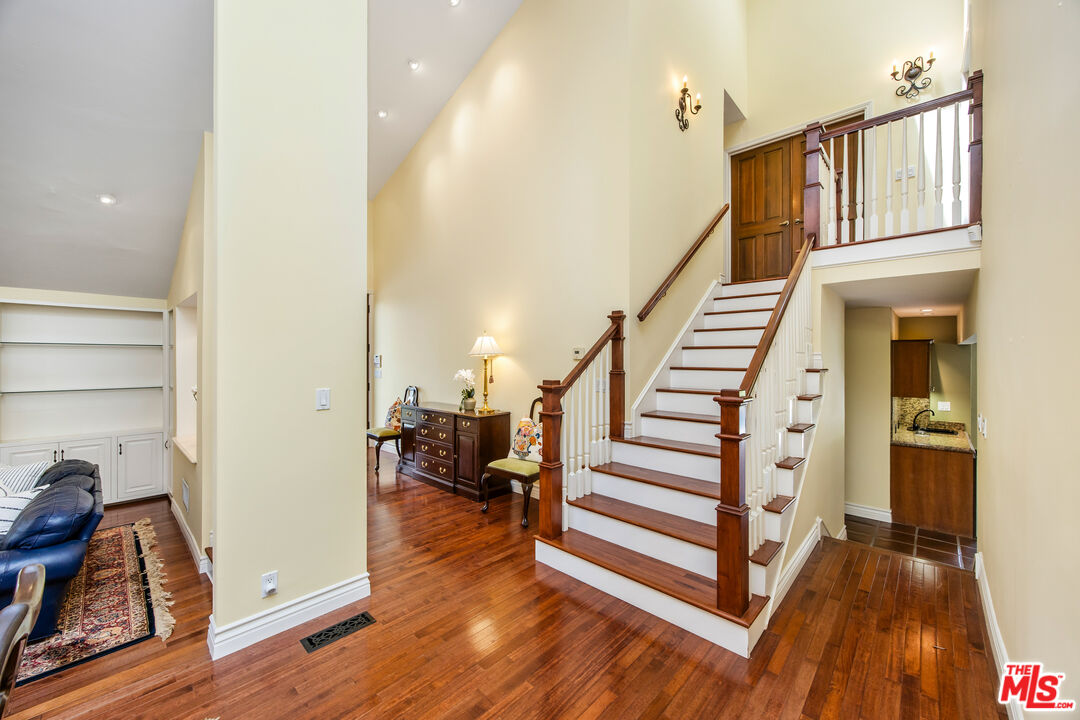 2124 Eric Drive Los Angeles, CA 90049 - Photo 17 of 30 a view of a hallway with wooden floor and staircase