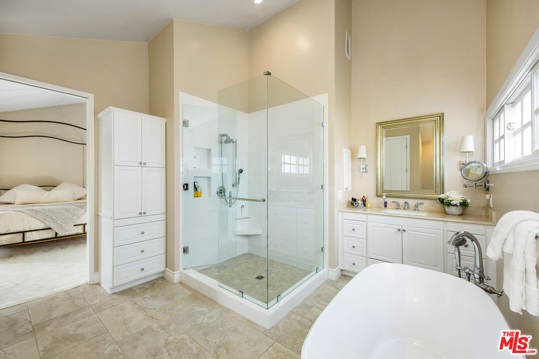 2124 Eric Drive Los Angeles, CA 90049 - Photo 20 of 30 a en suite bathroom with a granite countertop sink mirror and shower