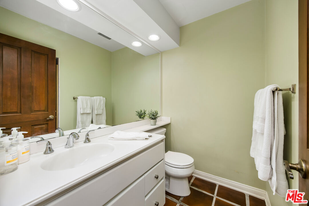 2124 Eric Drive Los Angeles, CA 90049 - Photo 23 of 30 a bathroom with a sink and a mirror