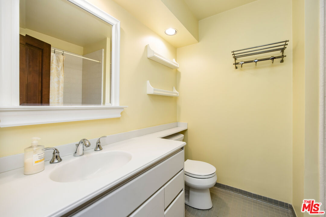 2124 Eric Drive Los Angeles, CA 90049 - Photo 25 of 30 a bathroom with a sink vanity mirror and toilet