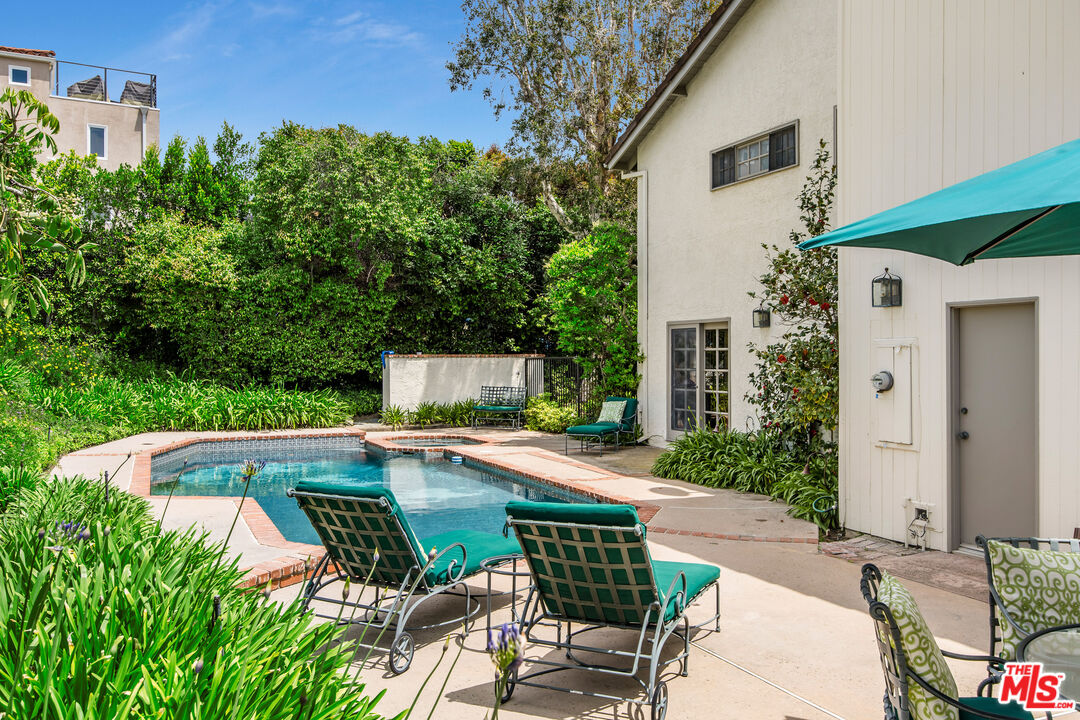 2124 Eric Drive Los Angeles, CA 90049 - Photo 27 of 30 a patio with table and chairs and potted plants