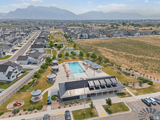 878 North Old Rnch Road Lehi, UT 84048 - Photo 23 of 36 Community amenities featuring a swimming pool, clubhouse with a metal roof, multiple shade structures, and manicured green spaces