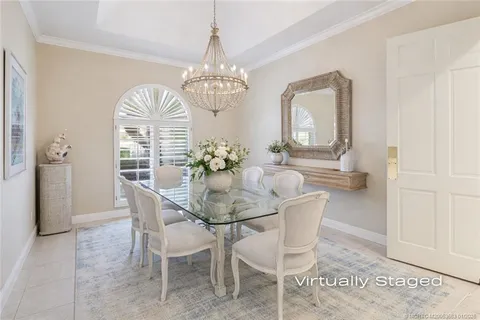a living room with furniture a fireplace and a chandelier