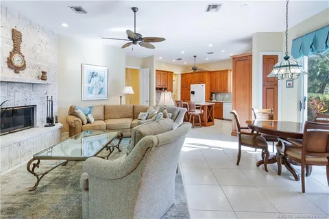 a living room with furniture a dining table and a fireplace