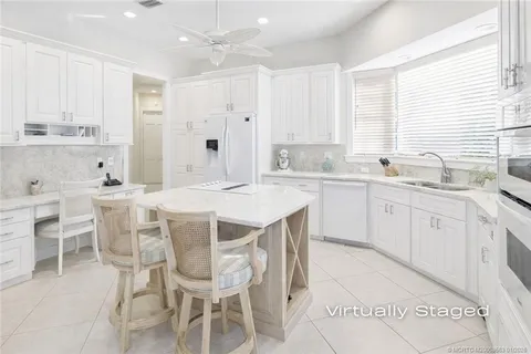 a kitchen with appliances cabinets and furniture