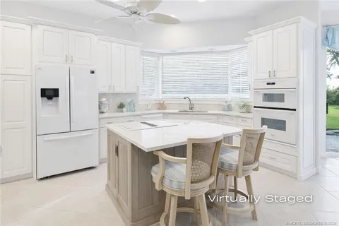 a spacious bedroom with a bed lamp and a large window