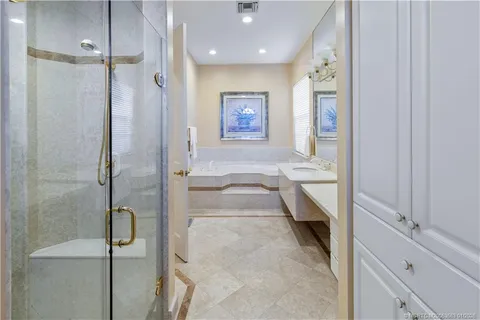 a bathroom with a double vanity sink a mirror and a shower