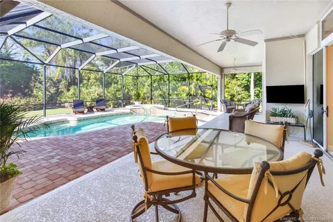a view of a dining room with furniture wooden floor and chandelier