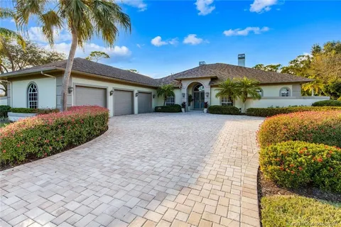 a aerial view of a house with yard and green space