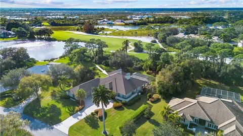 an aerial view of residential houses with outdoor space and river