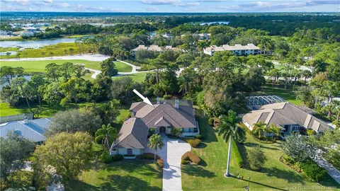 an aerial view of house with yard swimming pool and outdoor seating