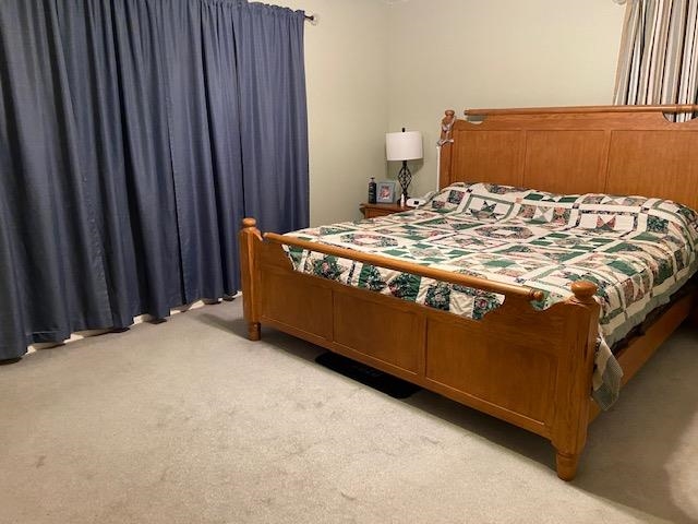 311 Rabbit Trail Road Leoma, TN 38468 - Photo 15 of 23 a bed sitting in a bedroom next to a wooden cabinet