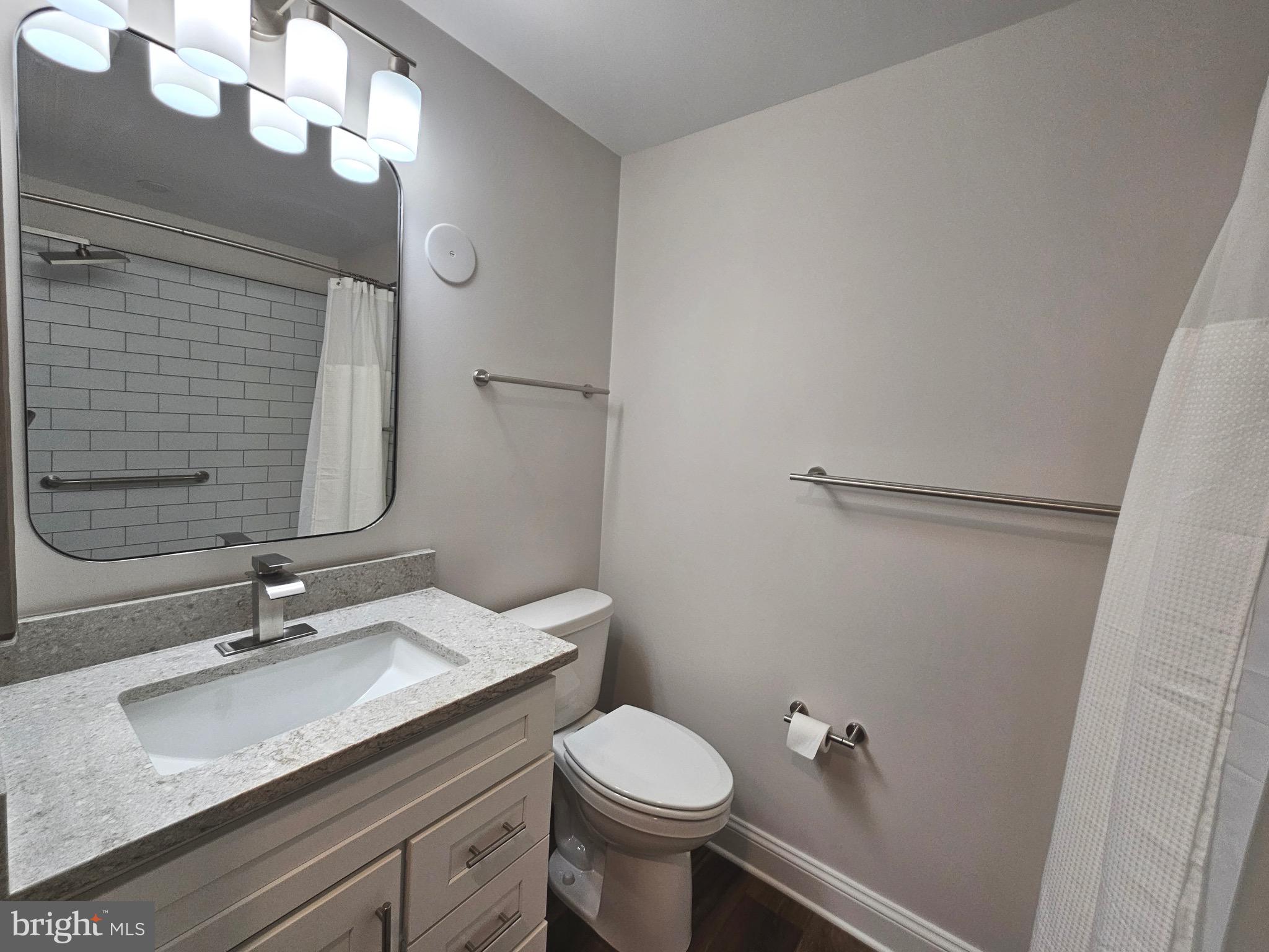 14400 Reva Road Reva, VA 22735 - Photo 13 of 14 a bathroom with a granite countertop sink toilet and a mirror