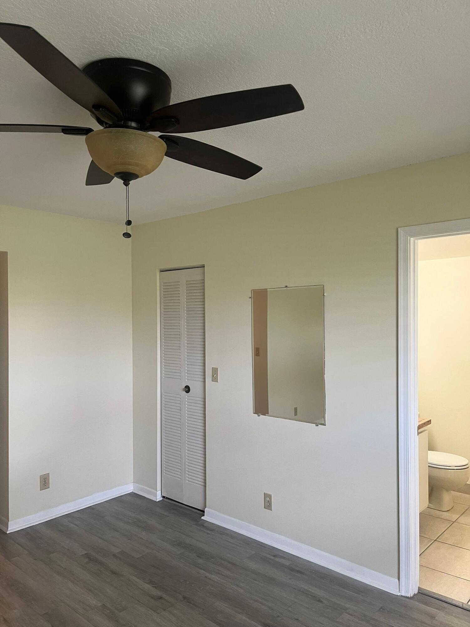 9993 Three Lakes Circle Boca Raton, FL 33428 - Photo 19 of 22 an empty room with wooden floor and windows