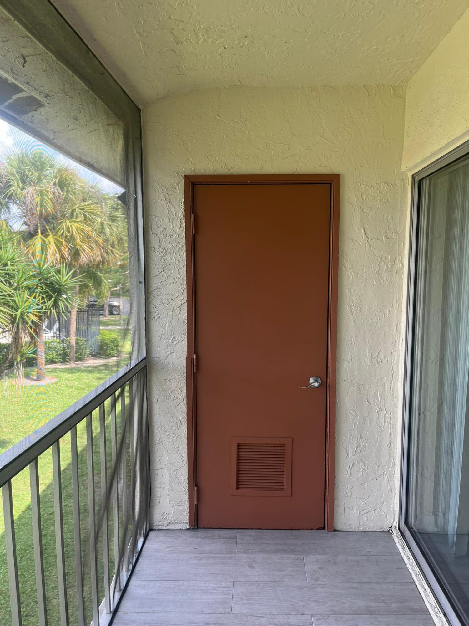 9993 Three Lakes Circle Boca Raton, FL 33428 - Photo 21 of 22 a view of a hallway with wooden floor and windows